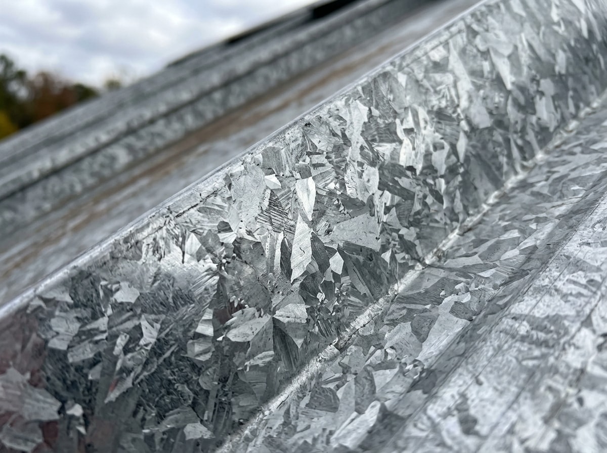 Close-up of galvalume roof panel coating showing aluminum-zinc finish
